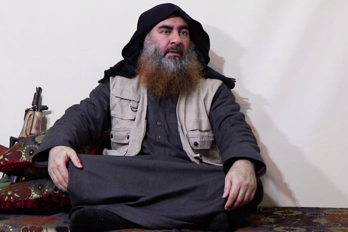 Dayesh head Abu Bakar al Baghdadi in sitting pose with AK 47 in Syria ISIS e1582199564431