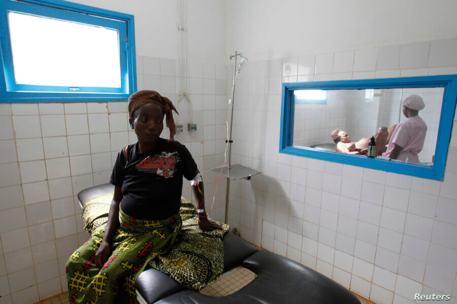 A pregnant woman waits while another goes into labour at the general hospital in Man