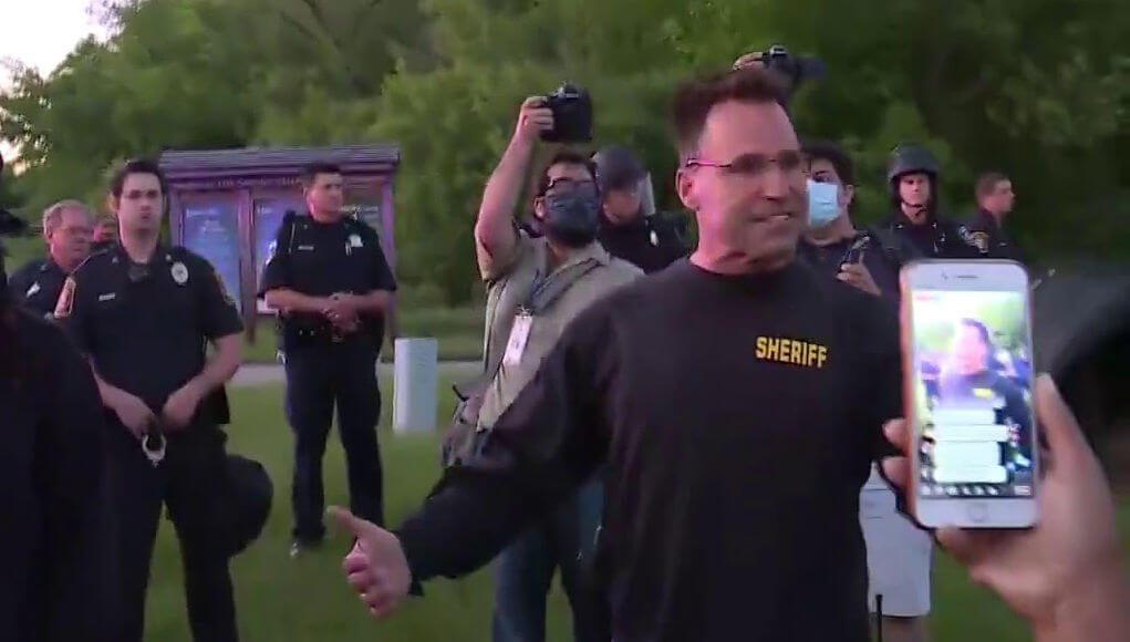 Policeman Chris Swanson joins George Floyd protestors in Michigan