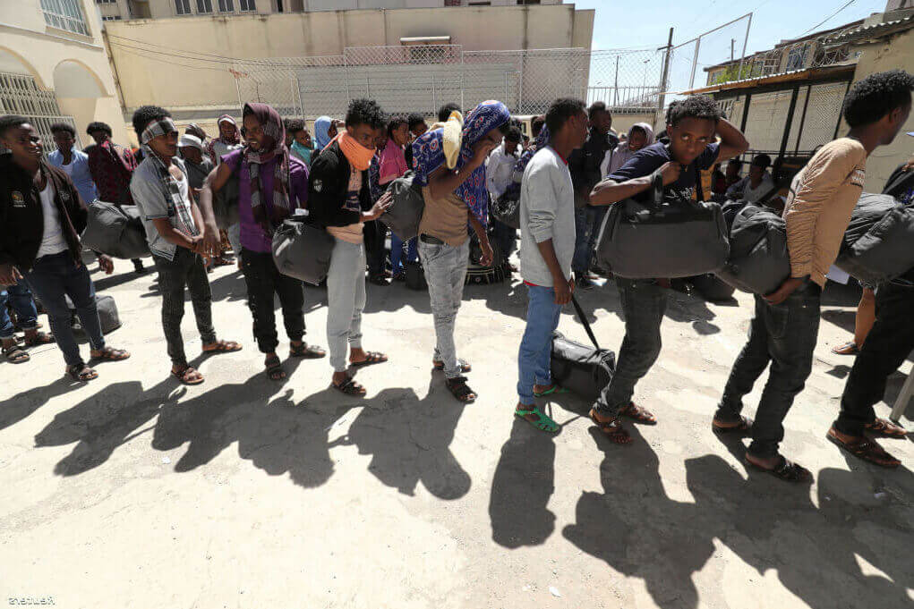 Ethiopian migrants wait to be registered at a International Organization for Migration (IOM) temporary shelter after being returned from Yemen to the capital Addis Ababa