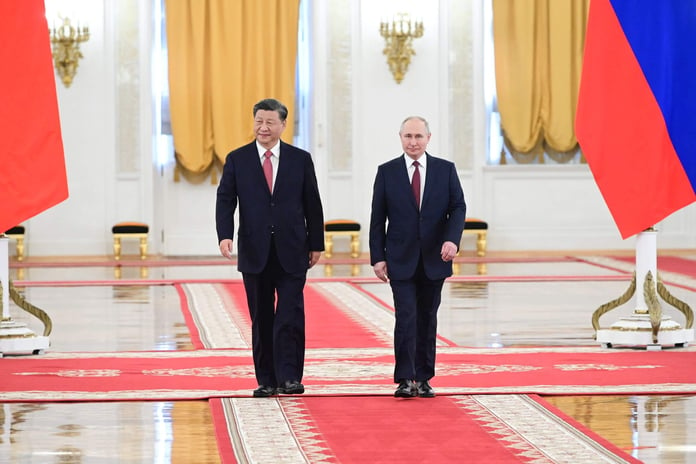 Putin, Xi Jinping in Kremlin sign statements on developing cooperation - Reuters

