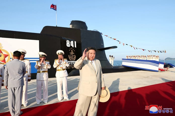 North Korean leader Kim Jong Un overseeing the submarine's inauguration and partaking in an onboard review