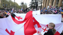 georgian people holding flag